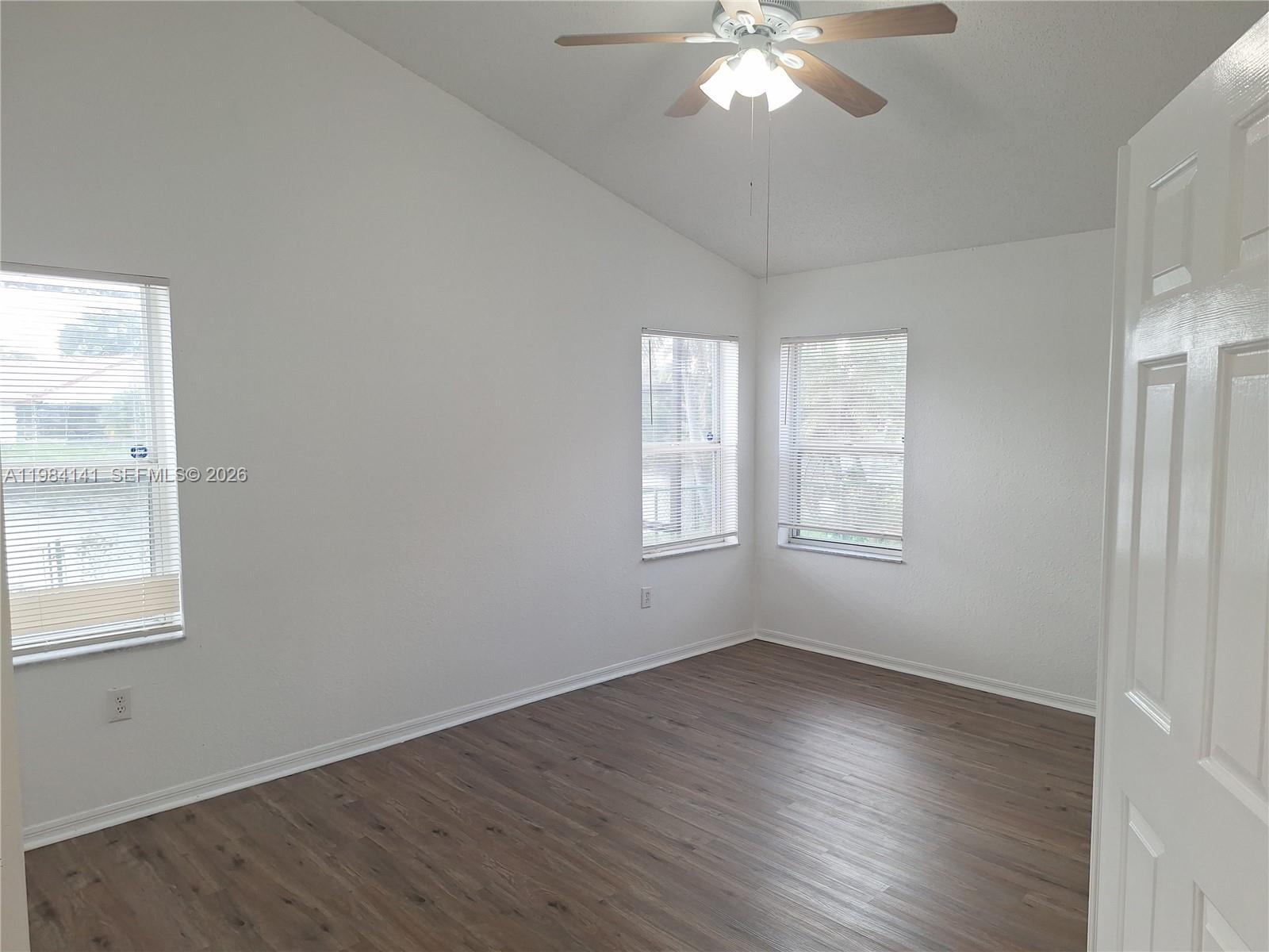 446 Lakeside Circle Sunrise, FL 33326 - Photo 8 of 13 an empty room with wooden floor and windows