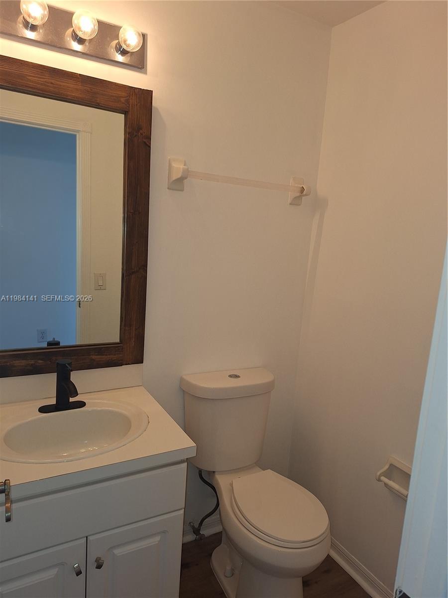 446 Lakeside Circle Sunrise, FL 33326 - Photo 10 of 13 a bathroom with a sink a toilet and mirror