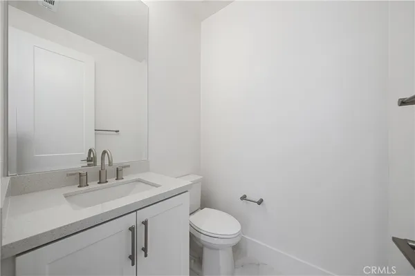 a bathroom with a sink toilet and a mirror