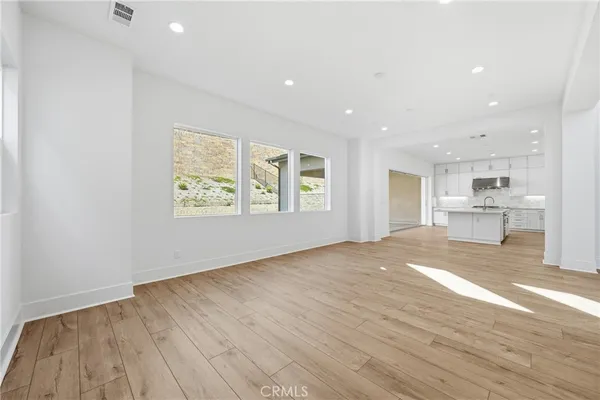 a open kitchen with white cabinets and stainless steel appliances