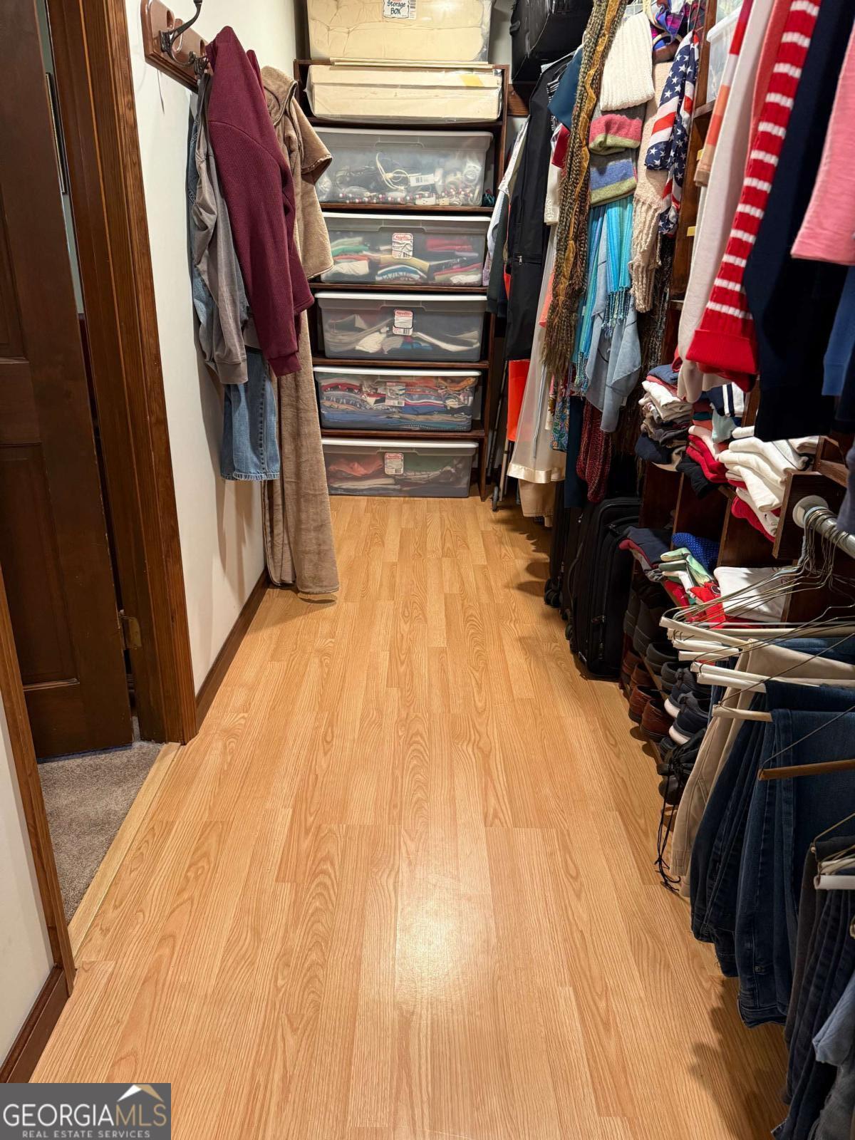 5686 Golden Isle West Baxley, GA 31513 - Photo 62 of 122 a view of walk in closet with clothes and shoes
