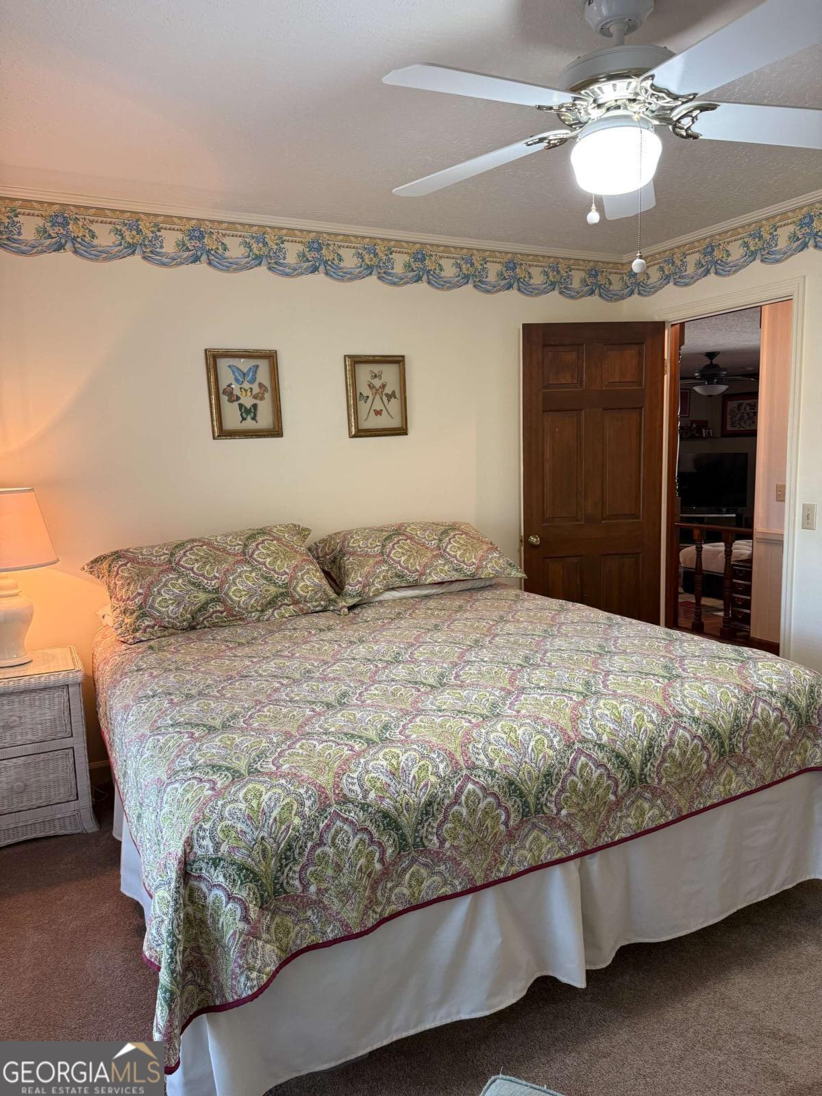5686 Golden Isle West Baxley, GA 31513 - Photo 97 of 122 a bedroom with a large bed and a flat tv screen on dresser