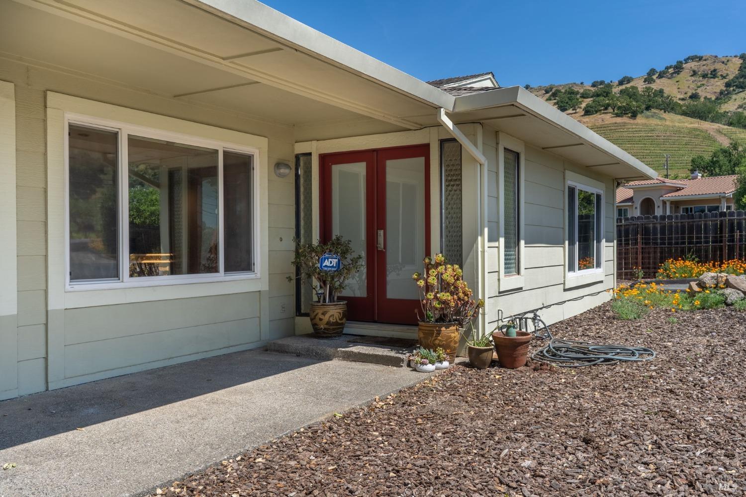 1550 Yountville Cross Road Napa, CA 94558 - Photo 11 of 45 a front view of a house with a garden