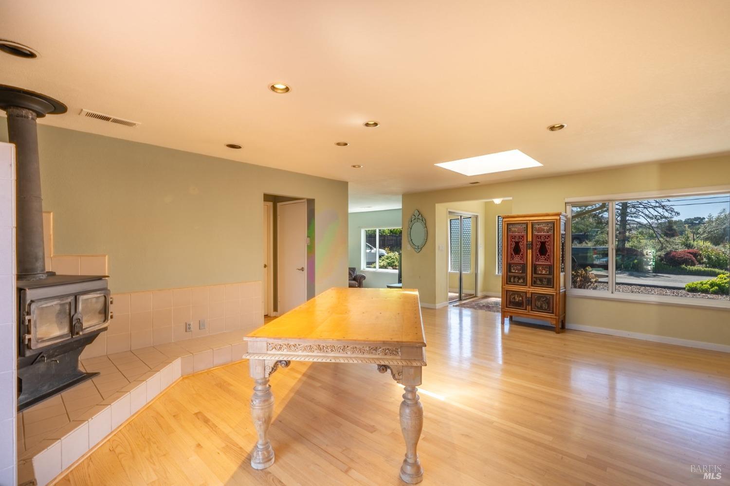 1550 Yountville Cross Road Napa, CA 94558 - Photo 15 of 45 a living room with a table and chairs with wooden floor