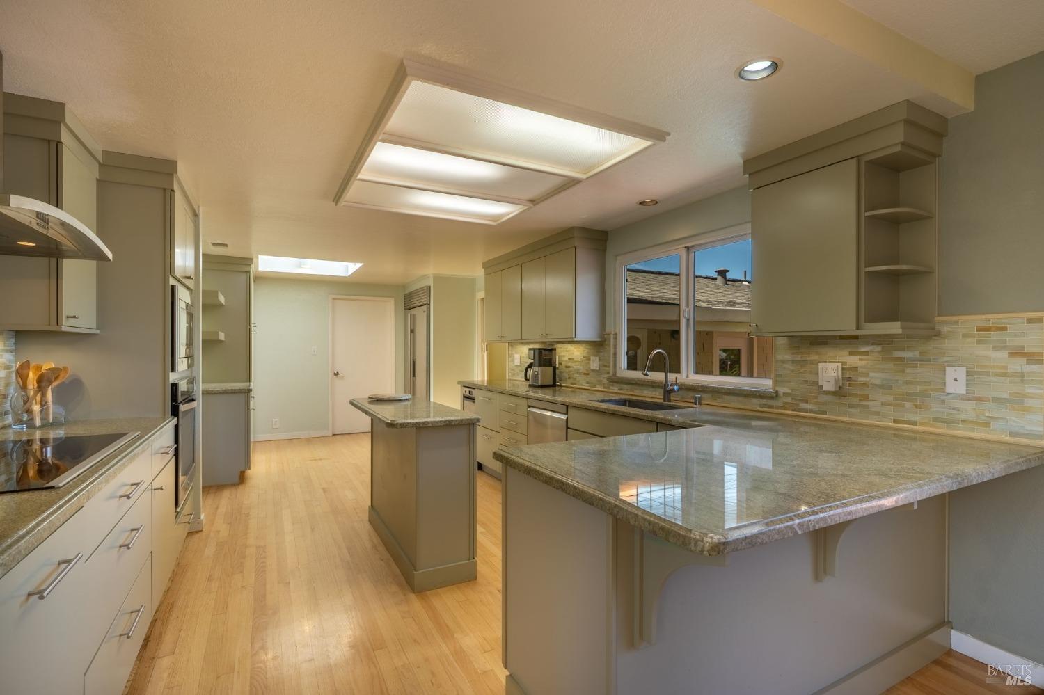 1550 Yountville Cross Road Napa, CA 94558 - Photo 20 of 45 a kitchen with stainless steel appliances granite countertop a sink stove and refrigerator