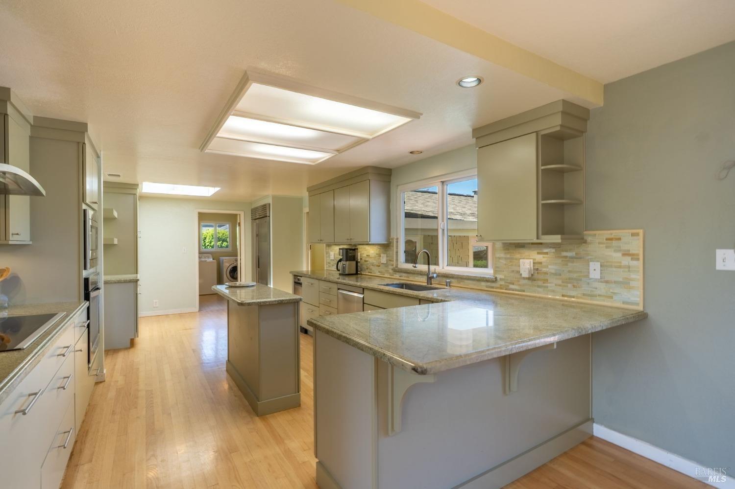 1550 Yountville Cross Road Napa, CA 94558 - Photo 21 of 45 a kitchen with sink stove and cabinets