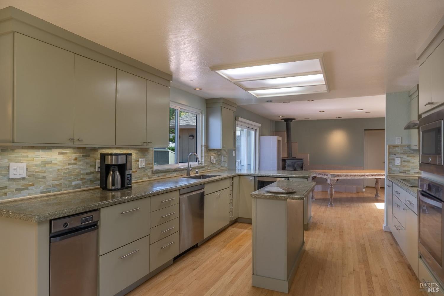 1550 Yountville Cross Road Napa, CA 94558 - Photo 26 of 45 a kitchen with stainless steel appliances a sink dishwasher stove refrigerator and cabinets