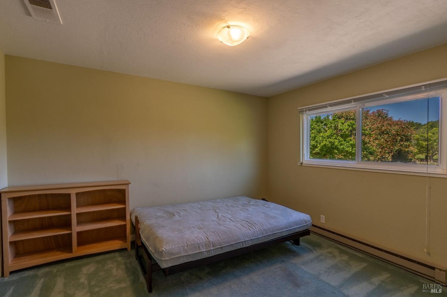 1550 Yountville Cross Road Napa, CA 94558 - Photo 29 of 45 a bedroom with a bed and a window