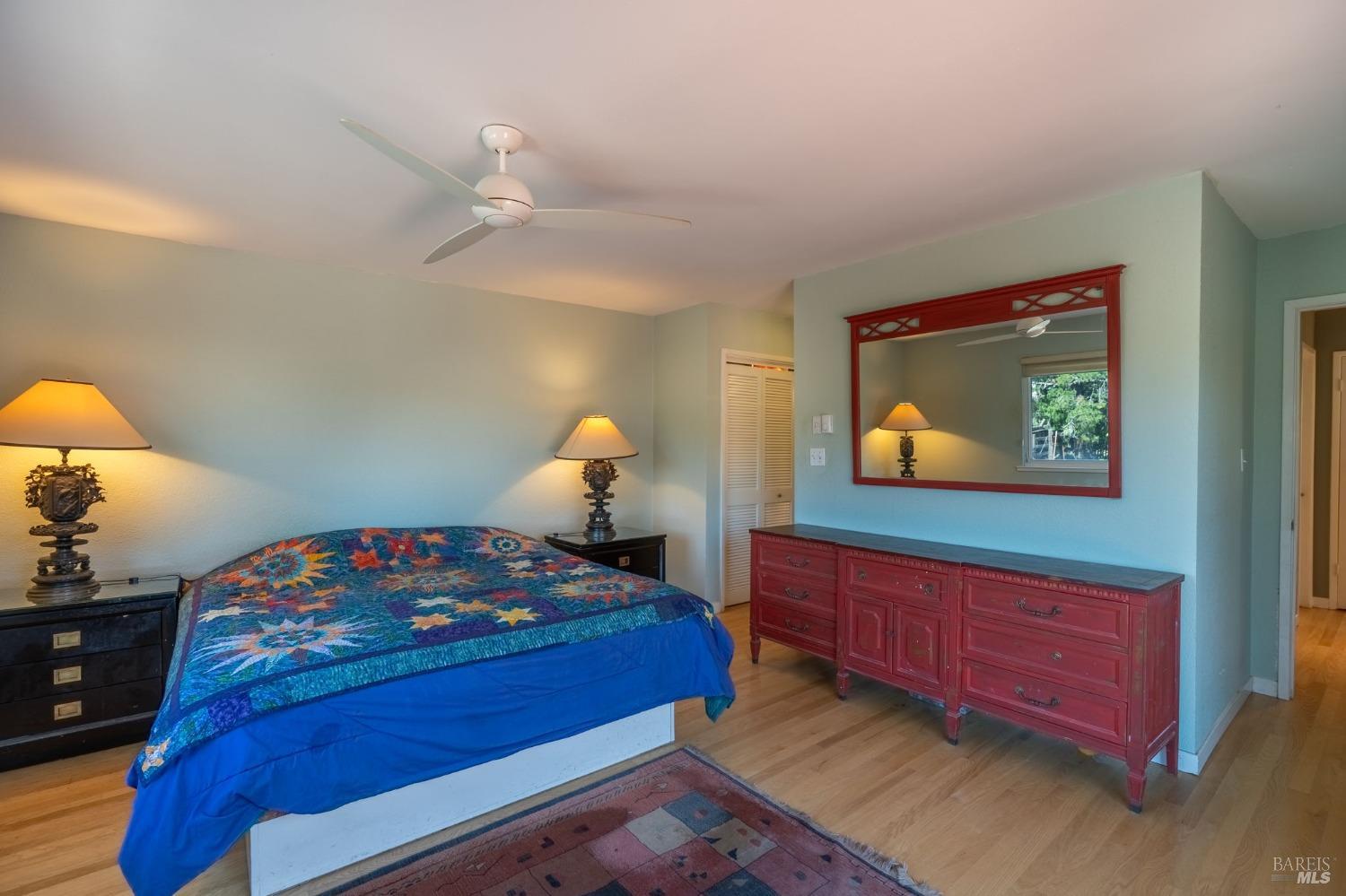 1550 Yountville Cross Road Napa, CA 94558 - Photo 34 of 45 a bedroom with bed and a chandelier