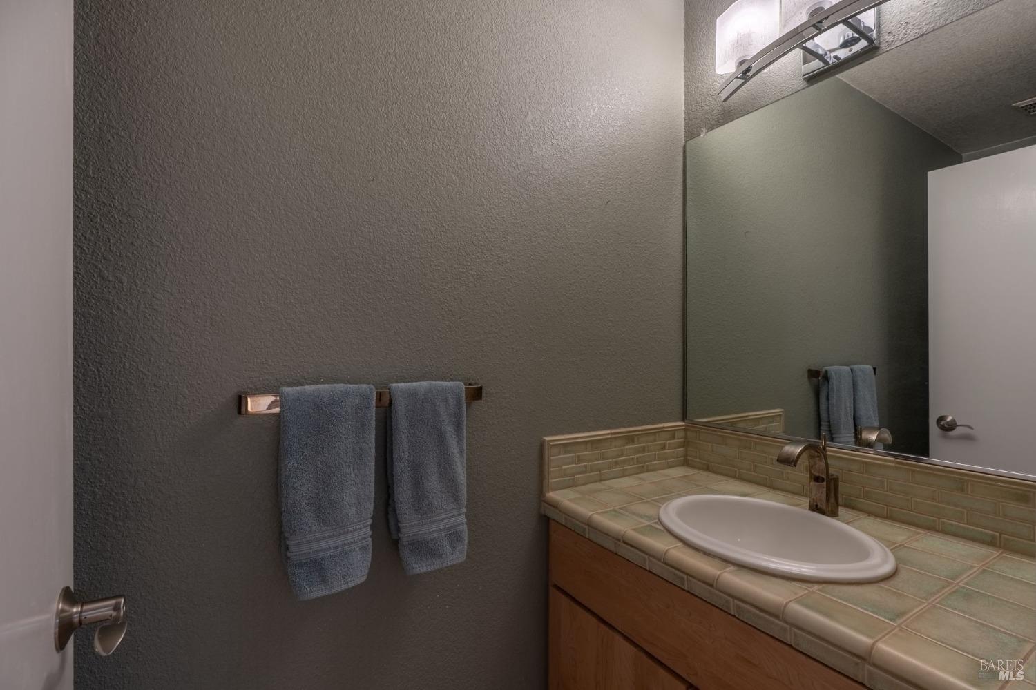 1550 Yountville Cross Road Napa, CA 94558 - Photo 38 of 45 a bathroom with a sink and a mirror