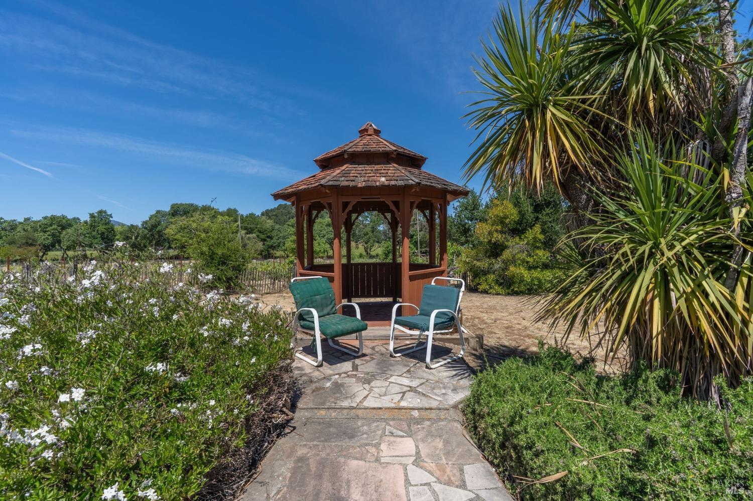 1550 Yountville Cross Road Napa, CA 94558 - Photo 42 of 45 a view of a chair and table in the garden