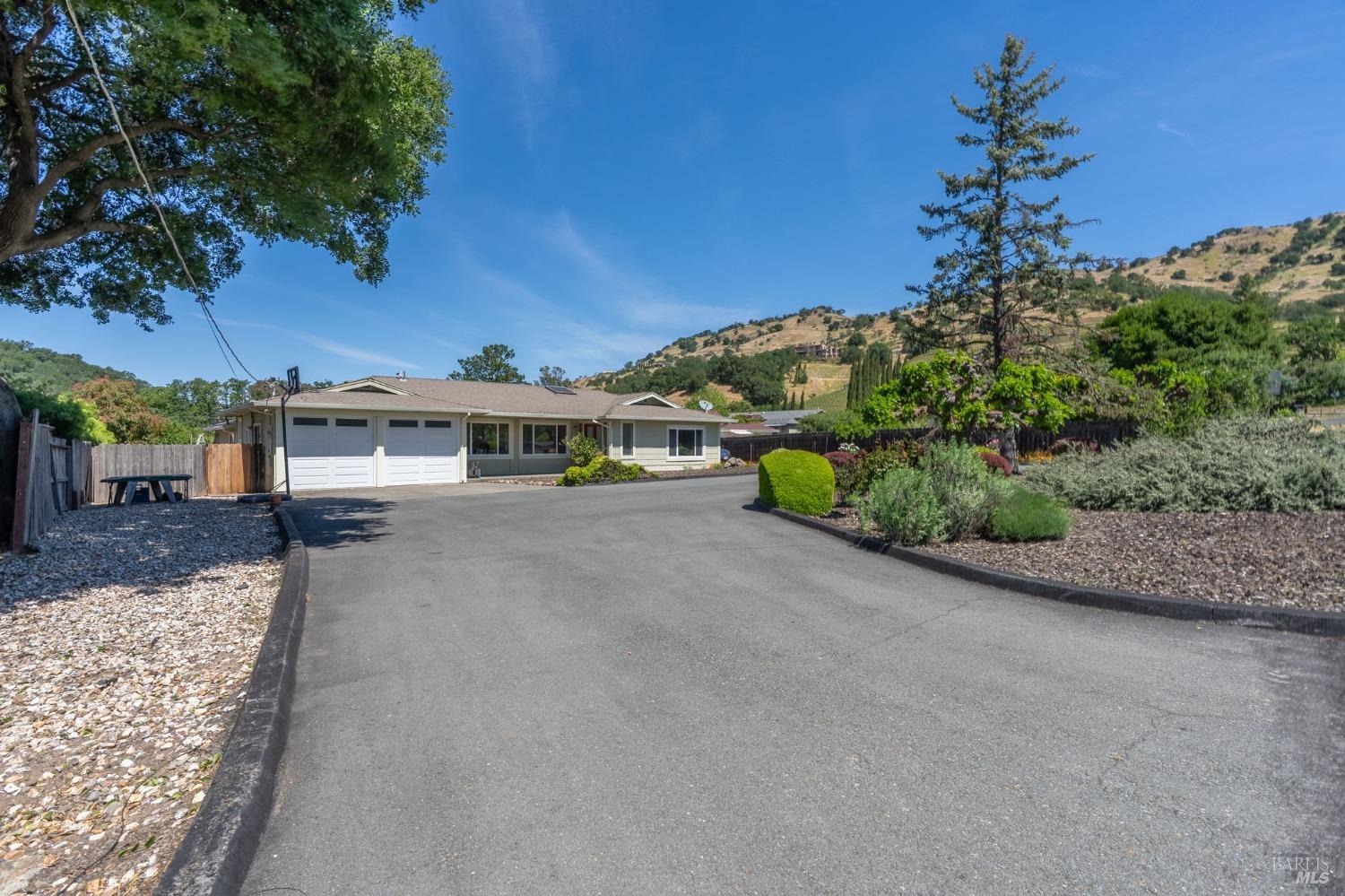 1550 Yountville Cross Road Napa, CA 94558 - Photo 8 of 45 a front view of a house with a yard and garage