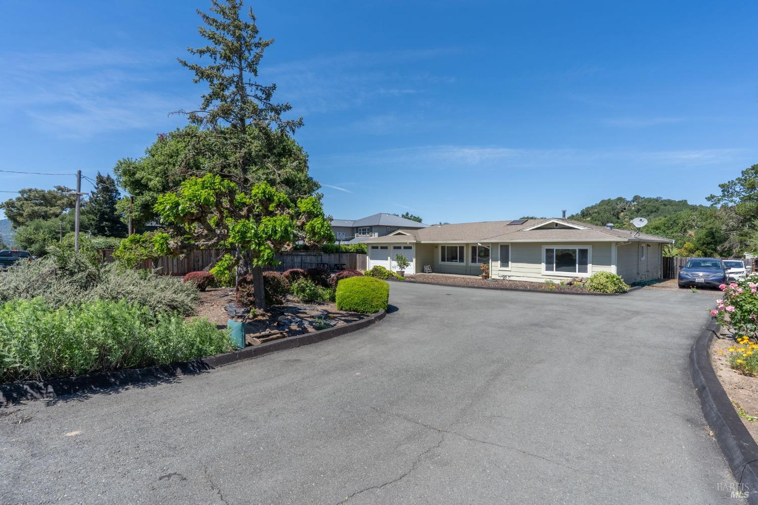 1550 Yountville Cross Road Napa, CA 94558 - Photo 9 of 45 a front view of a house with a garden
