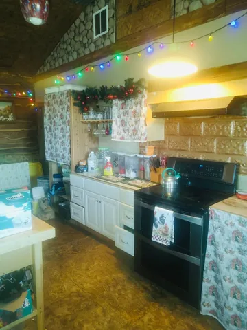 a view of a chairs and table in the back yard of the house