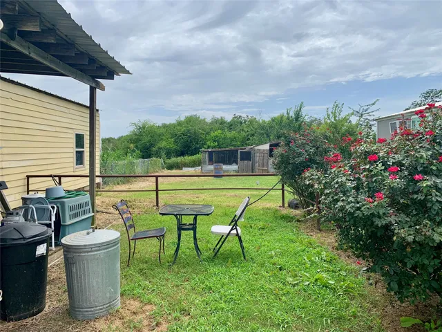 a view of a big yard with lots of green space