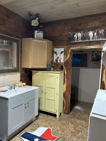 a kitchen with a sink and cabinets