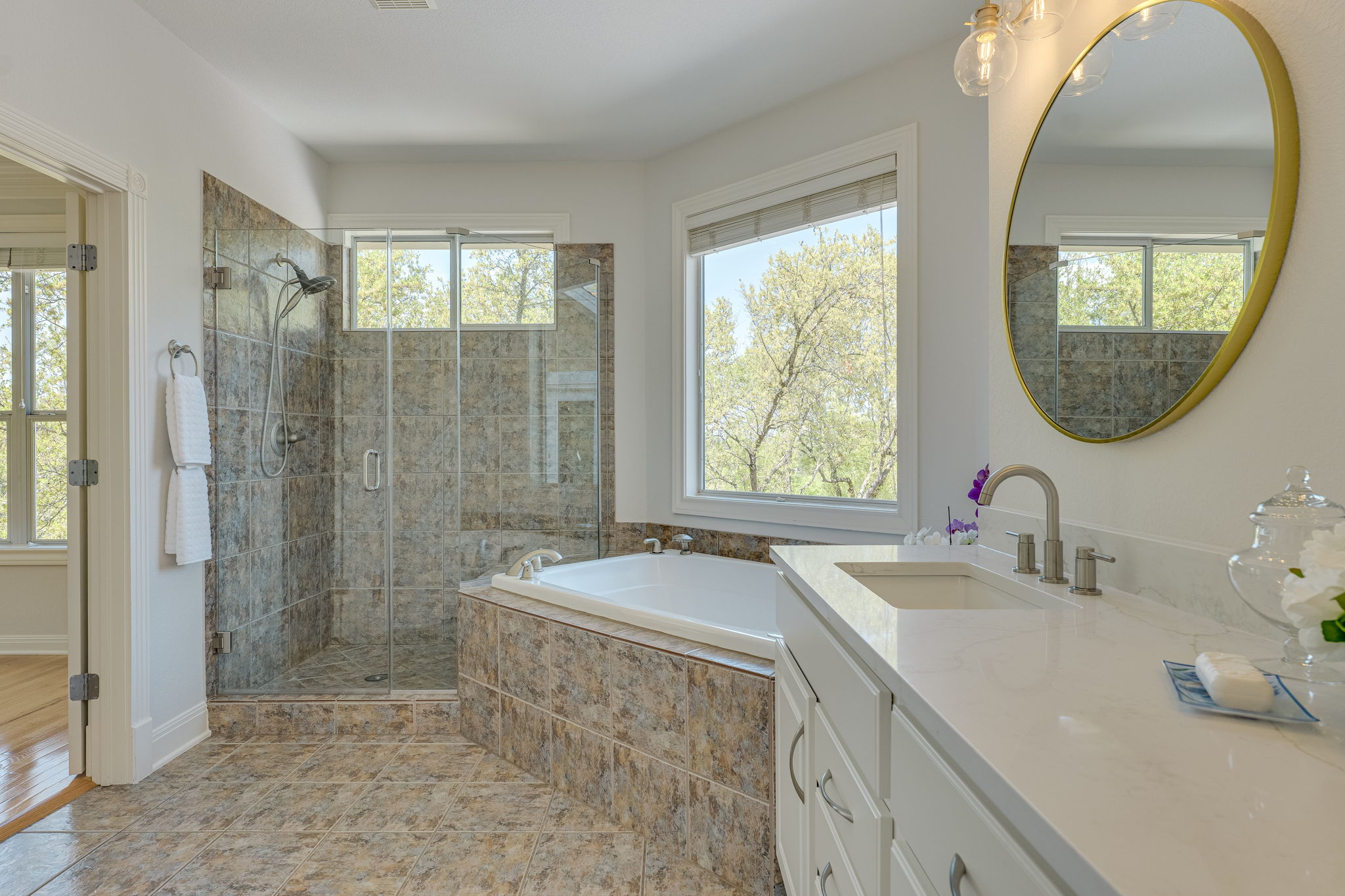 4424 Lago Viento Austin, TX 78734 - Photo 22 of 38 Primary bath has a window for natural light, walk-in frameless shower, dual sinks, water closet and walk-in closet.