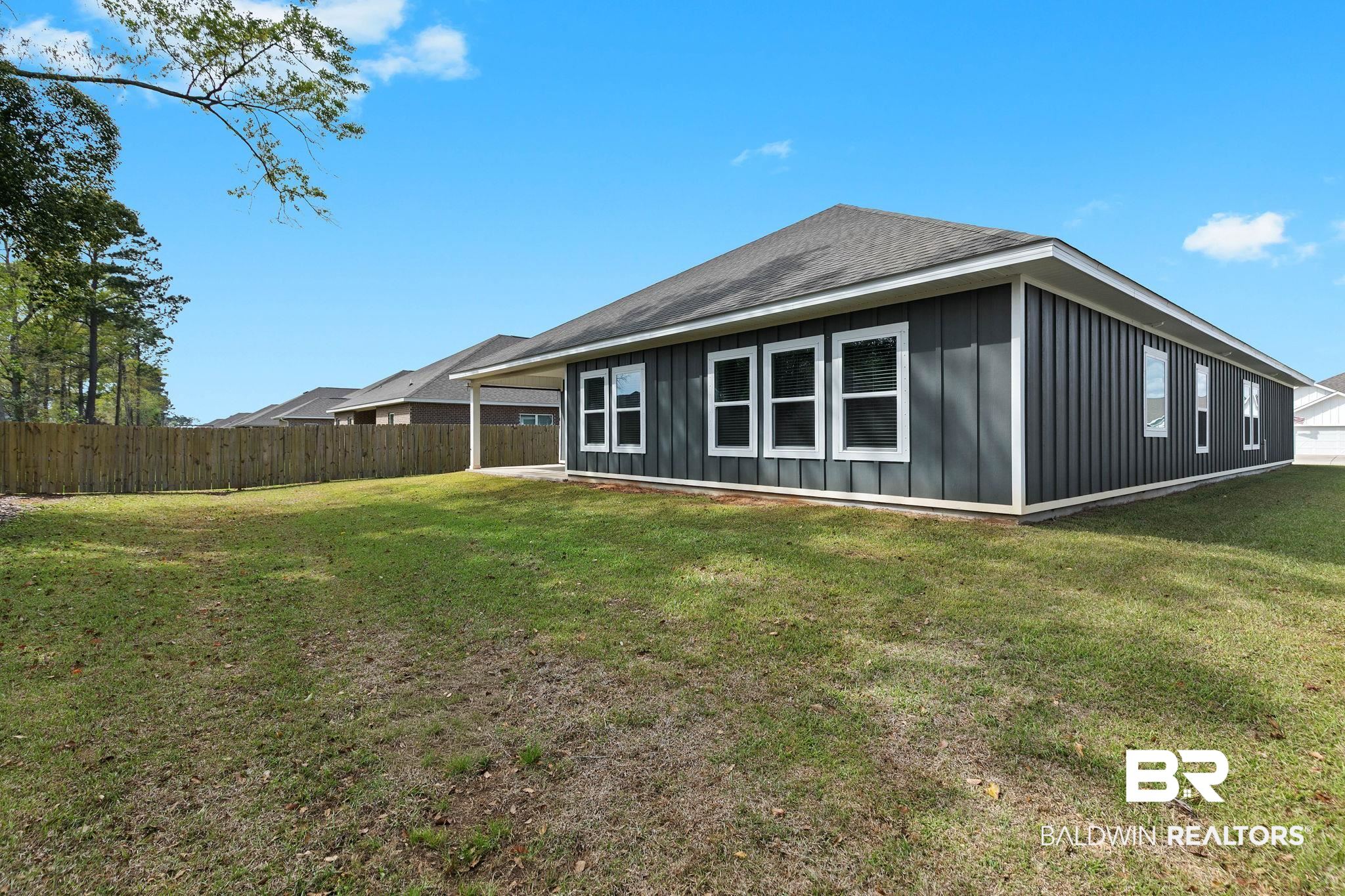 9448 Amethyst Drive Daphne, AL 36526 - Photo 56 of 61 Back of property with board and batten siding and roof with shingles