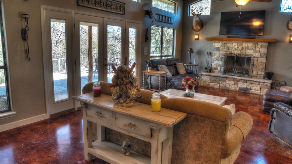 187 Roy Chisum Road Leakey, TX 78873 - Photo 11 of 40 a living room with furniture and a fireplace