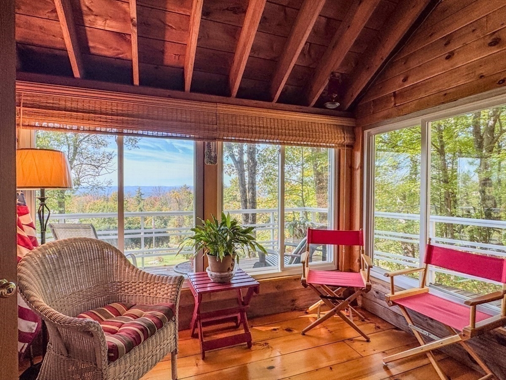261 Old Wendell Road Northfield, MA 01360 - Photo 16 of 42 a living room with furniture and a floor to ceiling window