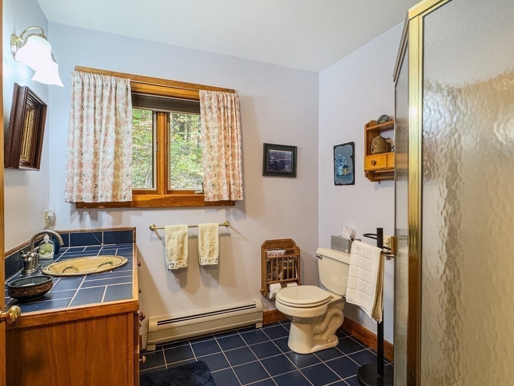 261 Old Wendell Road Northfield, MA 01360 - Photo 20 of 42 a bathroom with a sink toilet and shower