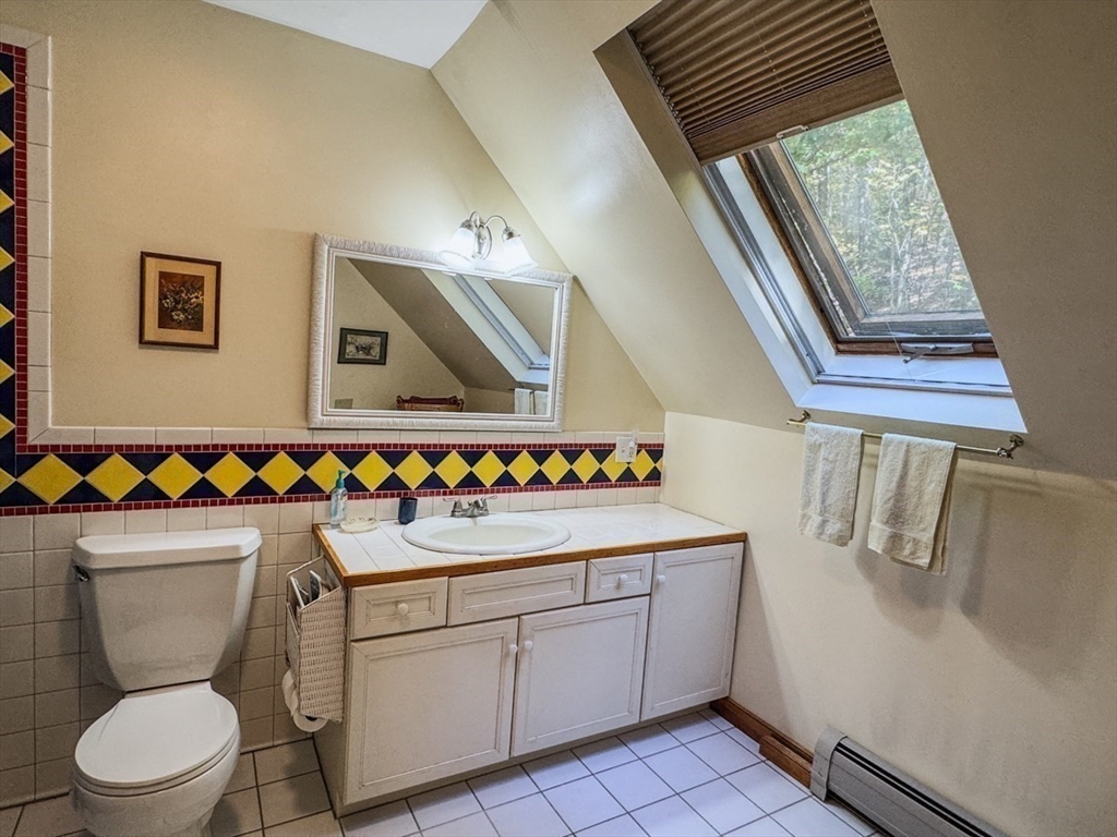 261 Old Wendell Road Northfield, MA 01360 - Photo 25 of 42 a bathroom with a sink toilet and window
