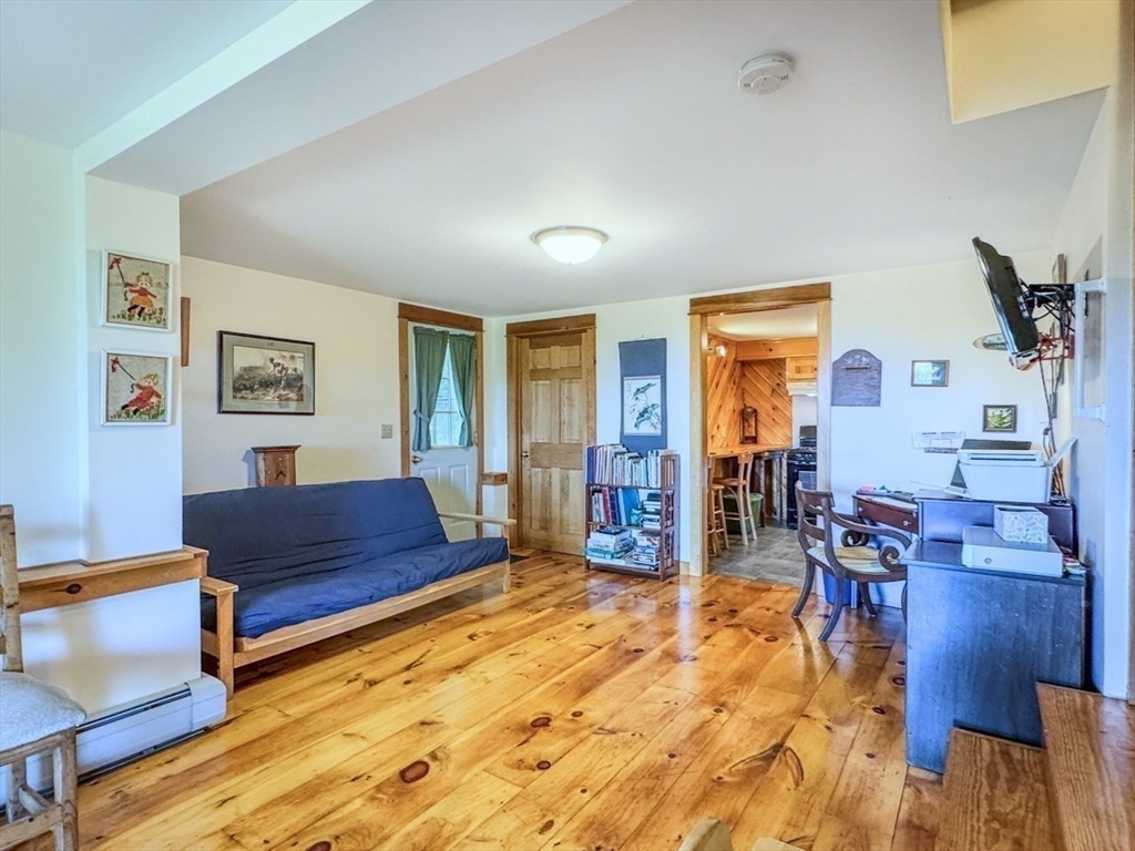 261 Old Wendell Road Northfield, MA 01360 - Photo 27 of 42 a bedroom with furniture and wooden floor