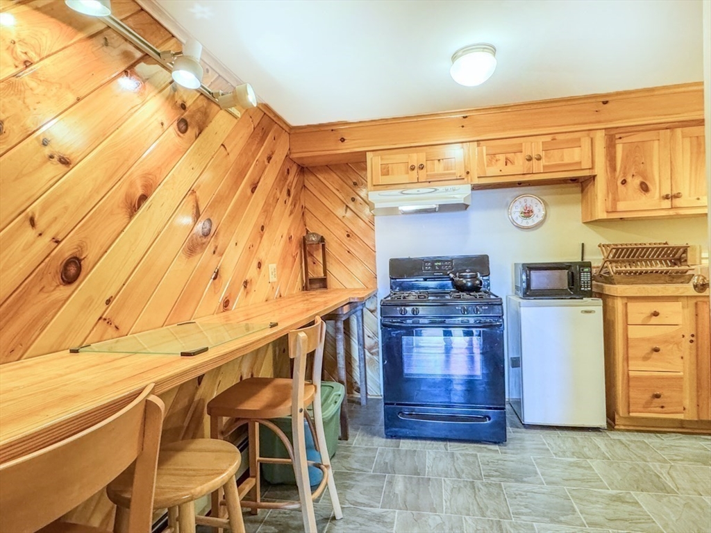 261 Old Wendell Road Northfield, MA 01360 - Photo 28 of 42 a kitchen with a stove and a refrigerator