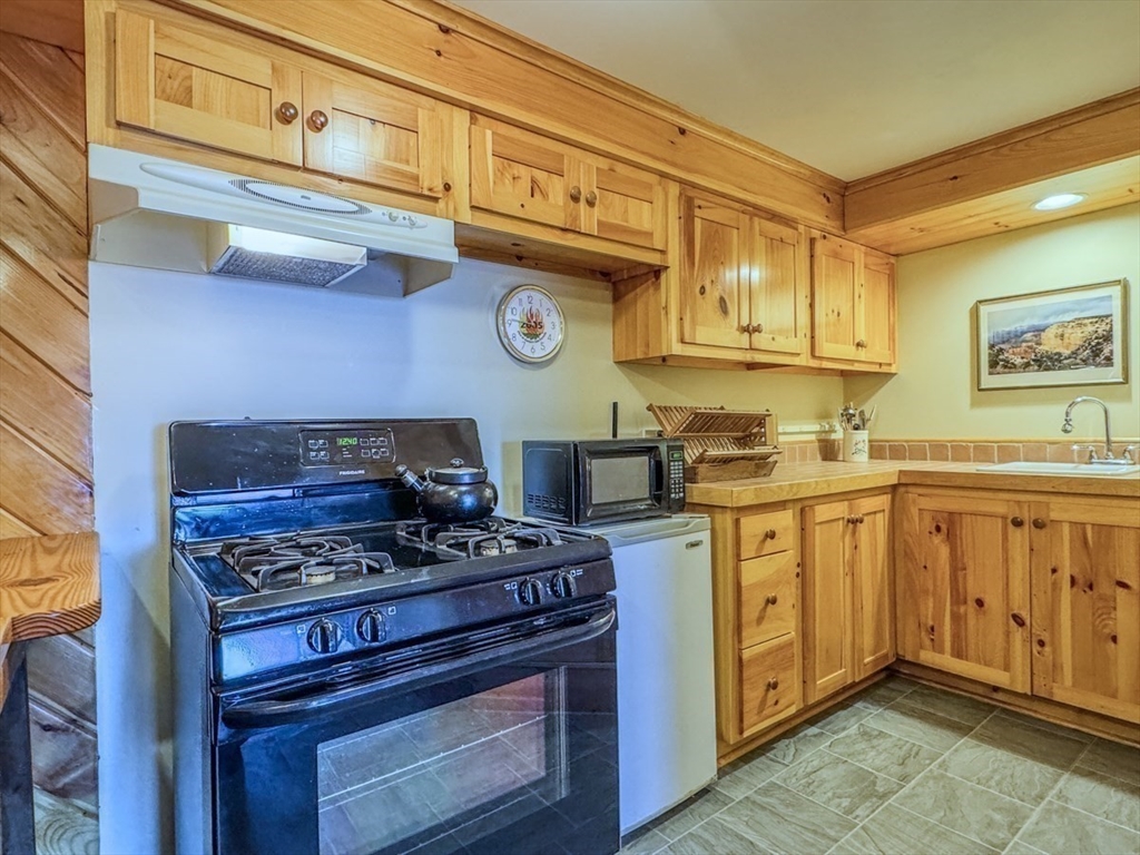261 Old Wendell Road Northfield, MA 01360 - Photo 29 of 42 a kitchen with stainless steel appliances granite countertop a stove and a refrigerator