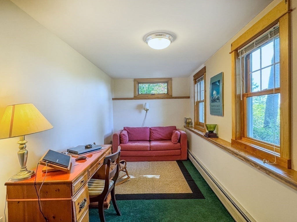 261 Old Wendell Road Northfield, MA 01360 - Photo 31 of 42 a living room with a couch and a chandelier