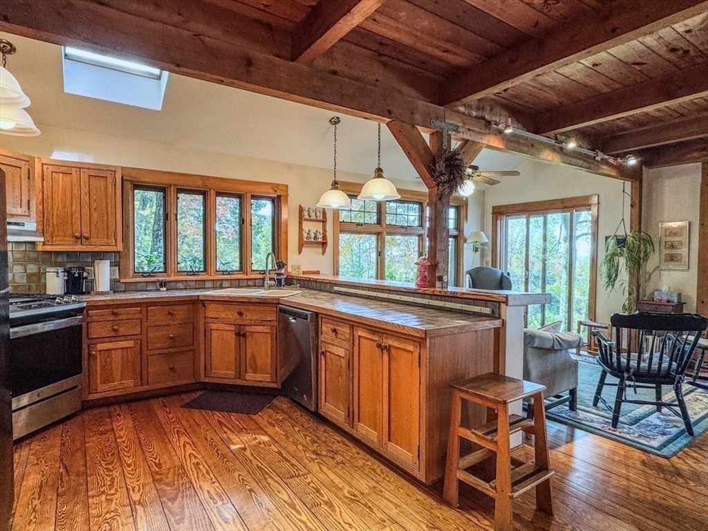 261 Old Wendell Road Northfield, MA 01360 - Photo 8 of 42 a large kitchen with cabinets and wooden floor