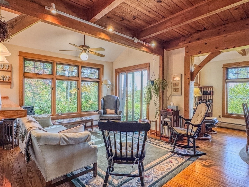 261 Old Wendell Road Northfield, MA 01360 - Photo 10 of 42 a living room with furniture and floor to ceiling windows