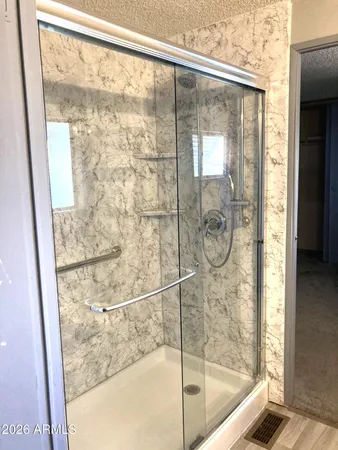 a bathroom with a glass shower door