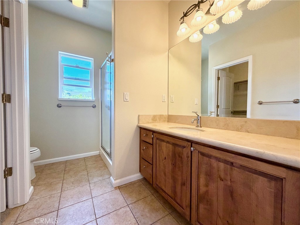 1037 Mark Twain Road Angels Camp, CA 95222 - Photo 29 of 52 a bathroom with a granite countertop sink a toilet and a mirror