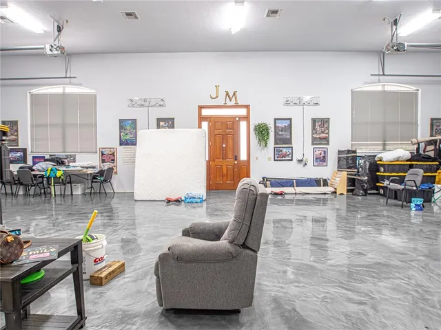 a kitchen with cabinets and chairs