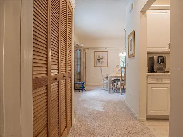 a bedroom with a bed lamp and paintings on the wall