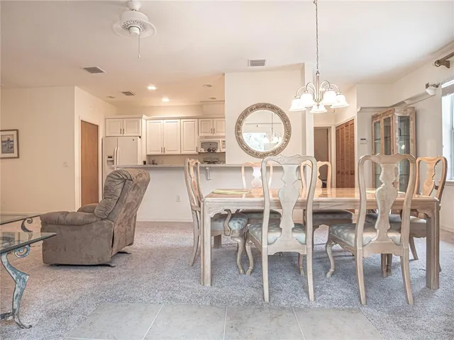 a spacious bedroom with a bed and a dresser