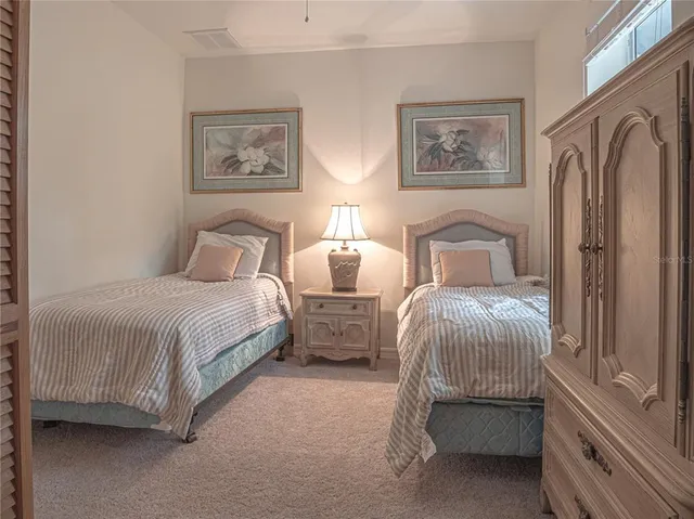 a large white kitchen with stainless steel appliances
