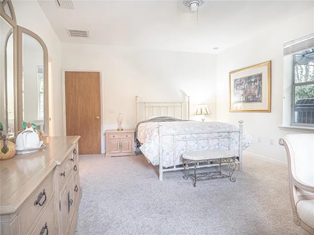 a view of a livingroom with furniture and a floor to ceiling window