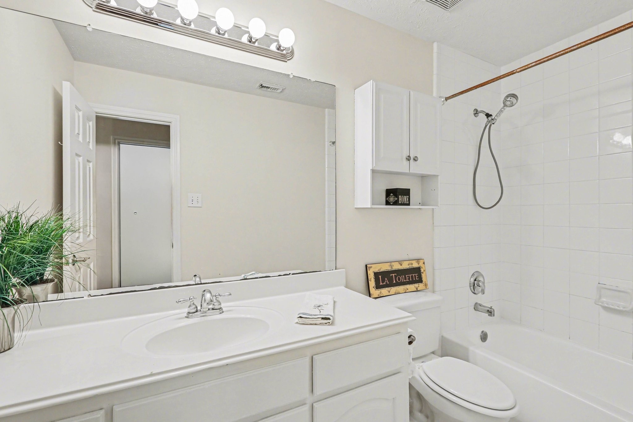 16434 Redcrest Drive Houston, TX 77095 - Photo 18 of 44 Full hall bath. Tub was repainted in April of 2026 and new vanity lighting.