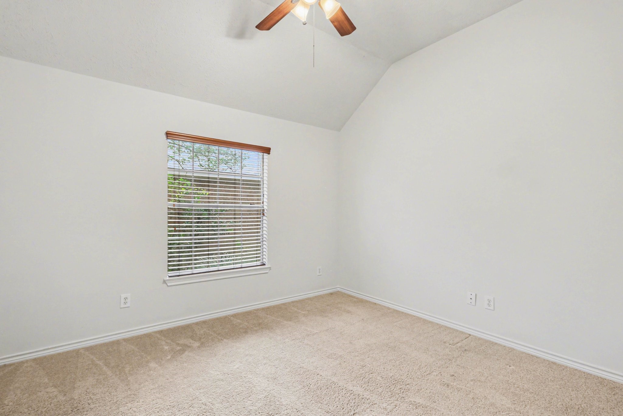 16434 Redcrest Drive Houston, TX 77095 - Photo 19 of 44 This is a cozy bedroom featuring a vaulted ceiling with a ceiling fan.