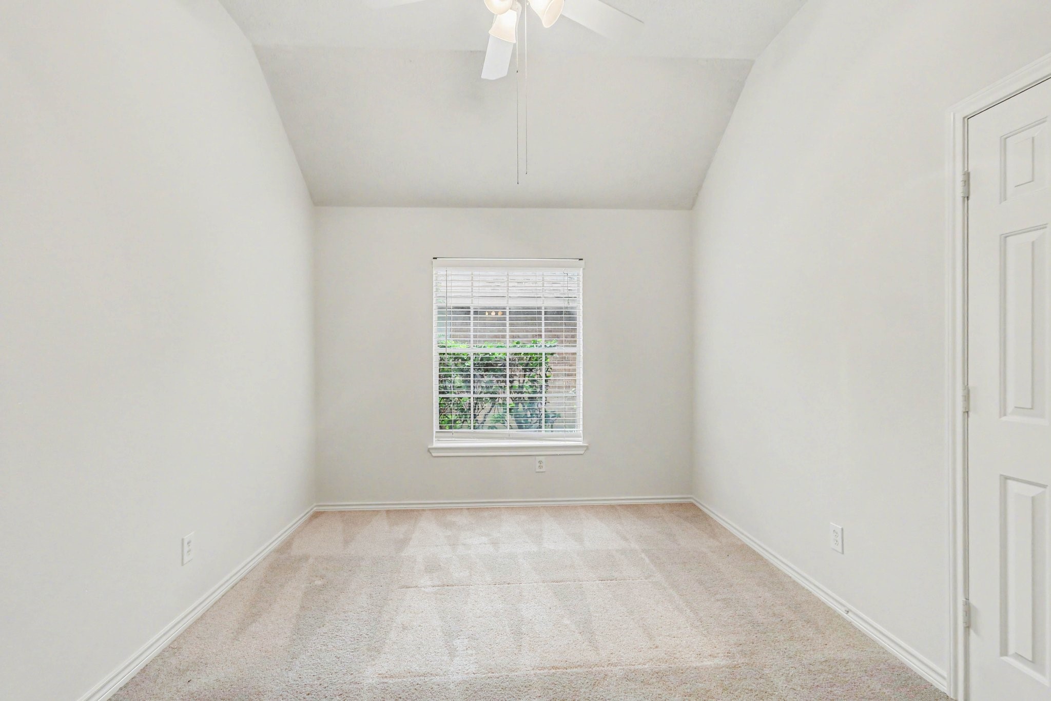 16434 Redcrest Drive Houston, TX 77095 - Photo 20 of 44 This is a charming children's bedroom with a blank canvas for your imagination to shine through. The room is well-lit with a ceiling fan and has a cozy, inviting atmosphere.