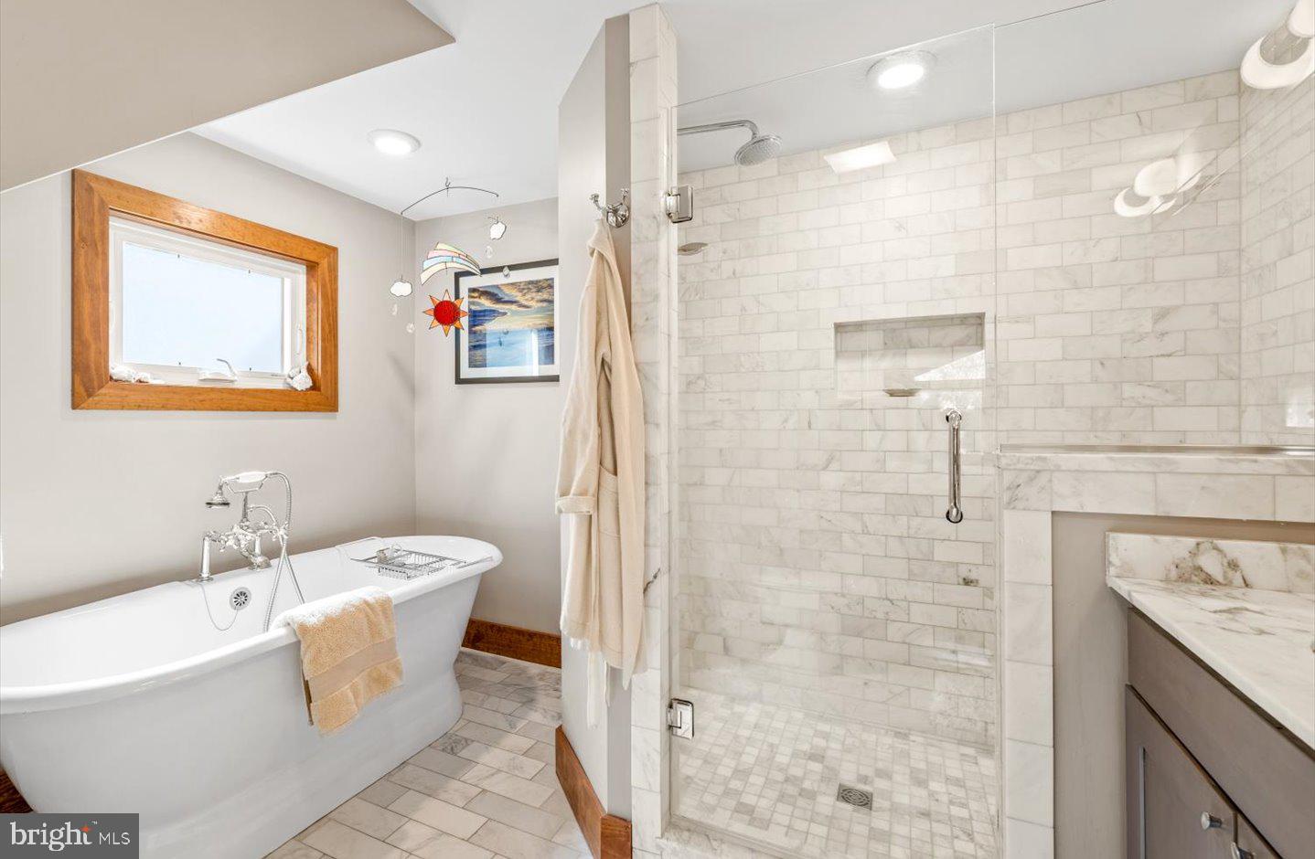 223 Rodney Street Rehoboth Beach, DE 19971 - Photo 34 of 59 a bathroom with a white bath tub a shower and a sink