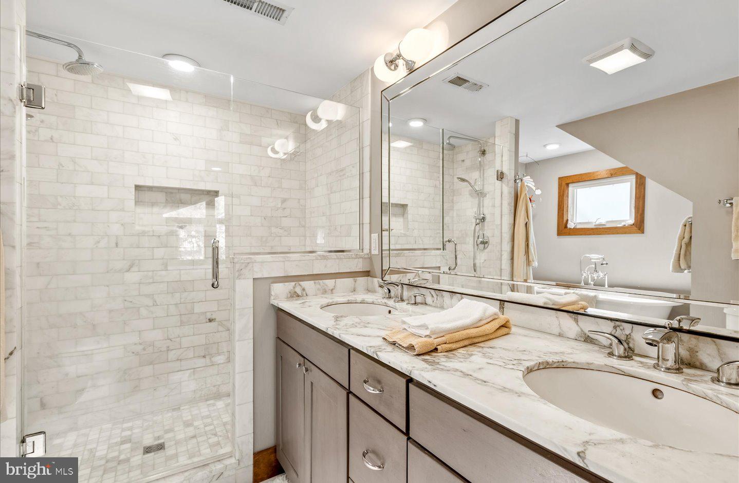 223 Rodney Street Rehoboth Beach, DE 19971 - Photo 35 of 59 a bathroom with a granite countertop sink mirror and double