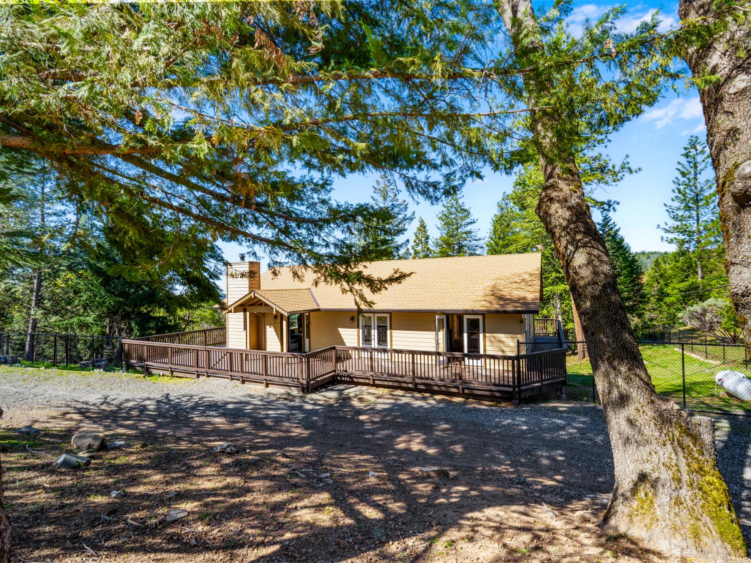 5031 Shooting Star Road Pollock Pines, CA 95726 - Photo 1 of 53 view of front facade with wooden deck