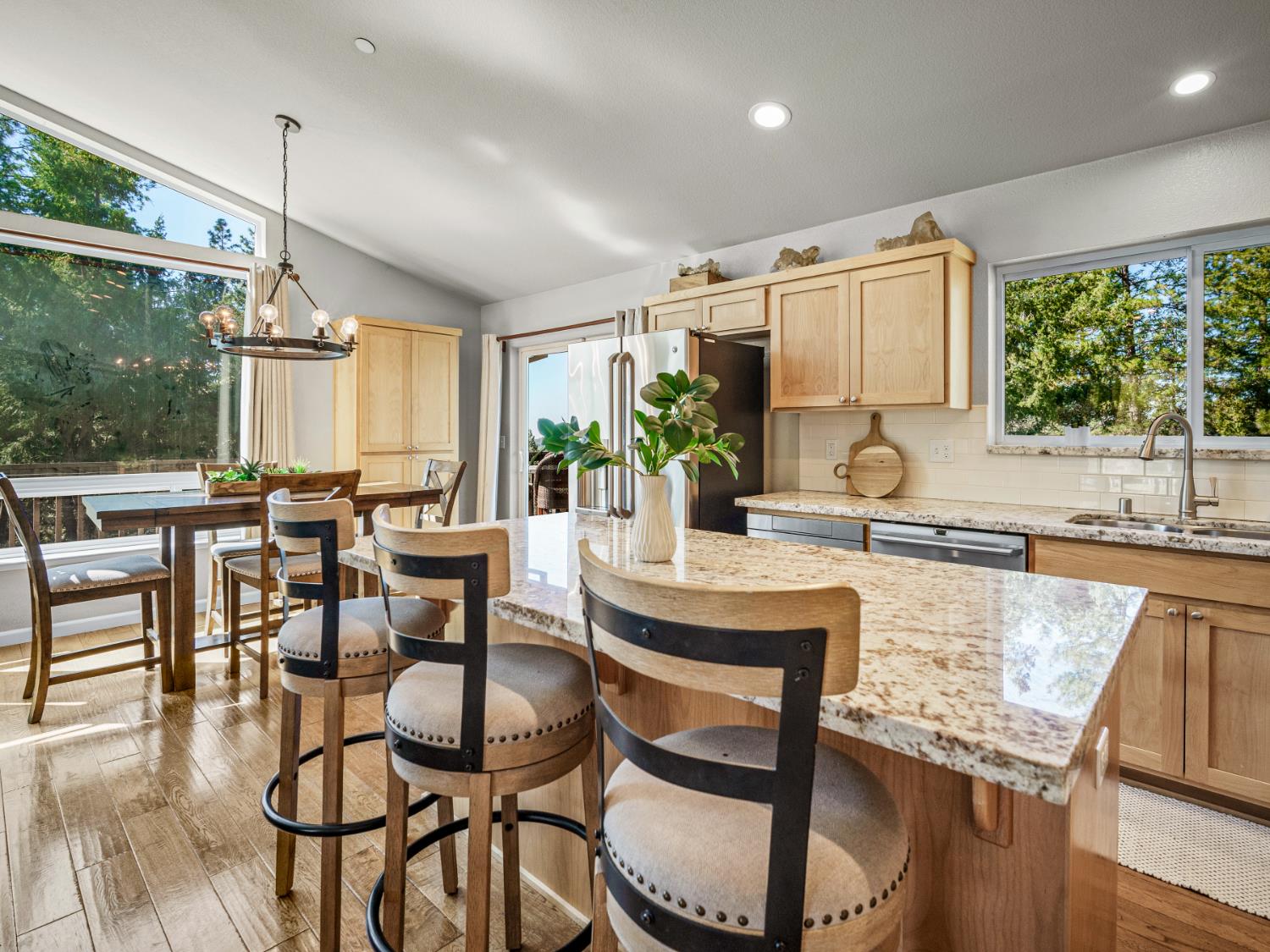 5031 Shooting Star Road Pollock Pines, CA 95726 - Photo 6 of 53 kitchen featuring granite counters, a kitchen bar, stainless steel appliances, and natural light