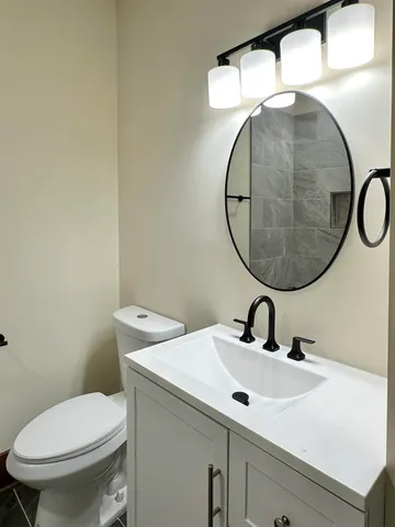 a bathroom with a sink a mirror and a toilet