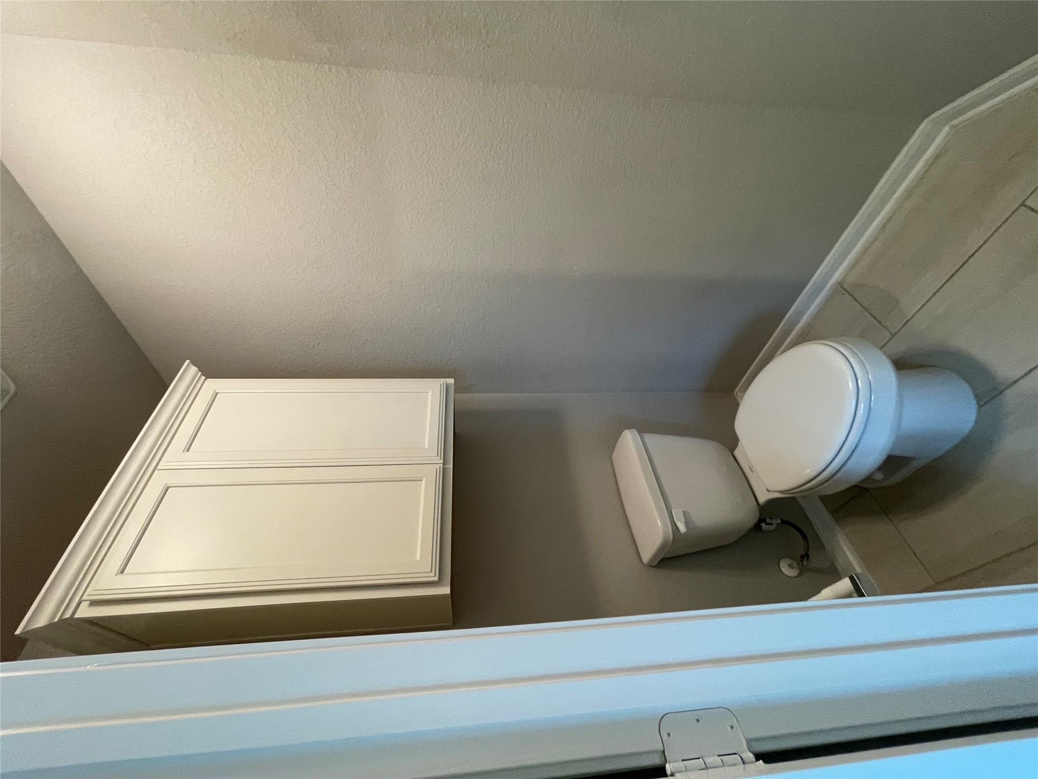 8113 Northgate Loop Temple, TX 76502 - Photo 20 of 35 Powder room featuring a built-in white cabinet with crown molding, a standard white toilet, light gray walls, white baseboards, and light-toned tile flooring