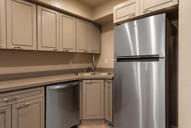 a kitchen with stainless steel appliances a refrigerator and cabinets