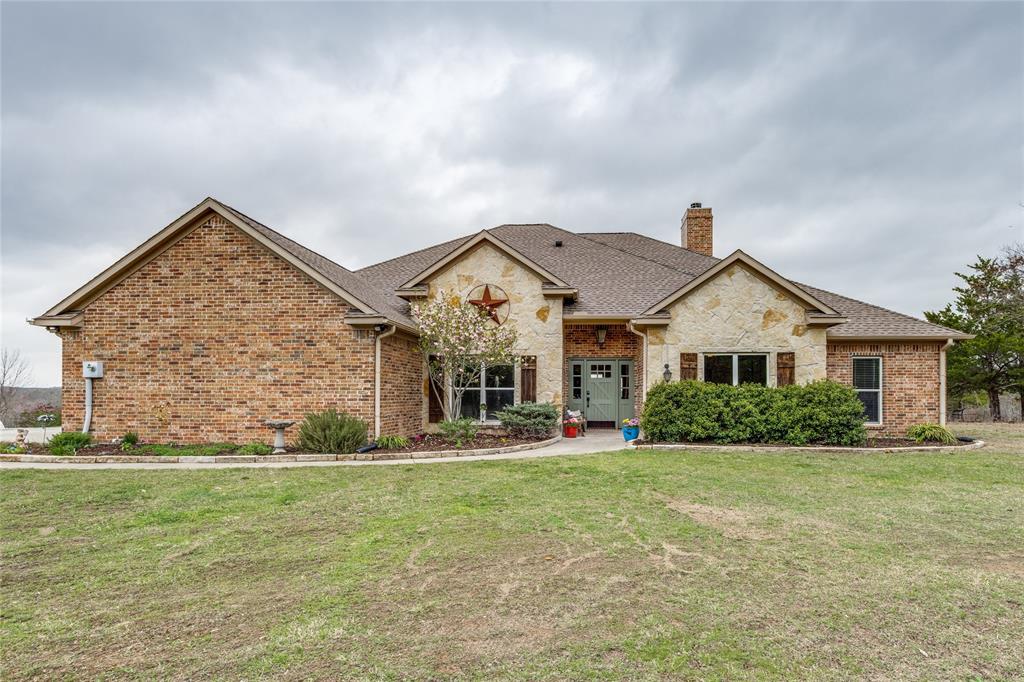1462 Durham Road Whitewright, TX 75491 - Photo 1 of 40 a front view of a house with garden